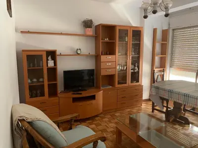 a living room with a tv and a entertainment center at PISO PLAYA SAN CIPRIÁN (MARIÑA LUCENSE) in San Ciprián