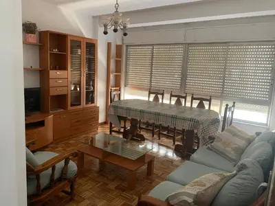 a living room with a couch and a table at PISO PLAYA SAN CIPRIÁN (MARIÑA LUCENSE) in San Ciprián