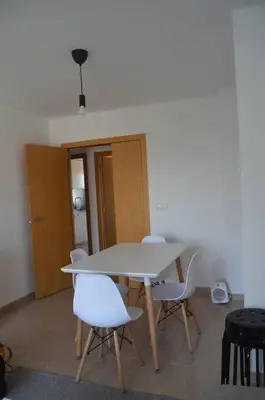 a white table and chairs in a room at Precioso apartamento con garaje en Ares. in Ares