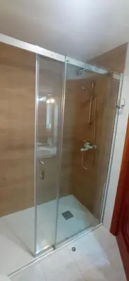 a shower stall in a bathroom with a sink at Pensión A Fonte in Caldas de Reis