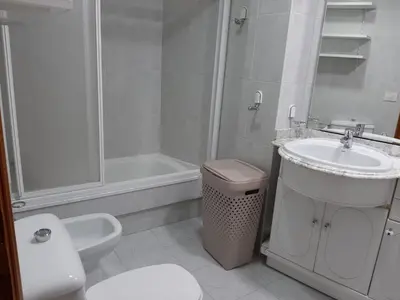 a bathroom with a toilet and a sink and a shower at Pensión A Fonte in Caldas de Reis