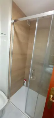 a shower with a glass door in a bathroom at Pensión A Fonte in Caldas de Reis