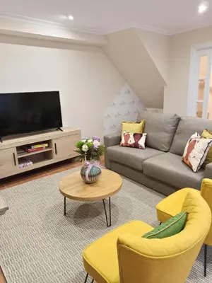 a living room with a couch and a tv at A casiña de Estela in Caldas de Reis