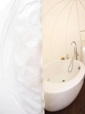 a white bath tub in a bathroom with a sink at Burbujas Astronómicas Albarari Coruña in Oleiros
