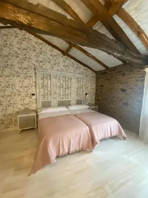a bedroom with a pink bed in a attic at Casa Meiga in Arzúa