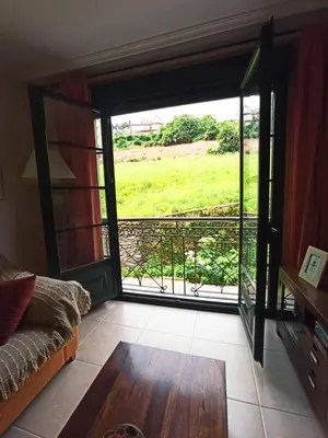 a room with a sliding glass door with a view of a field at Indiano 1K in Viveiro