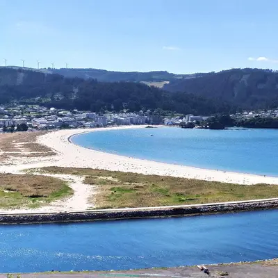 a view of a beach with a city in the background at Indiano 1K in Viveiro