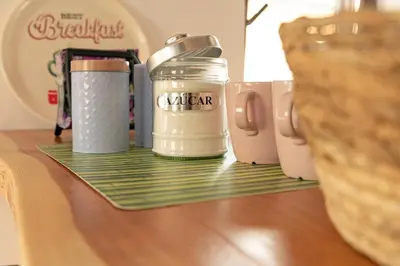 a shelf with two thermos on top of a table at O Lar do Camiñante in Palas de Rei