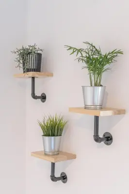 a pair of wooden shelves with potted plants on them at O Lar do Camiñante in Palas de Rei