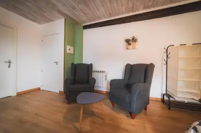 two chairs and a table in a room at O Noso Recuncho in Palas de Rei