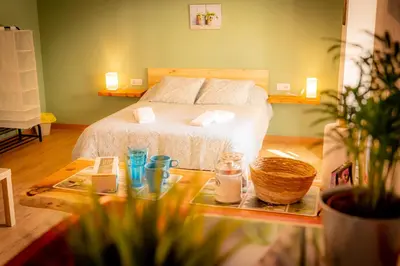 a bedroom with a bed and a table with candles at O Noso Recuncho in Palas de Rei