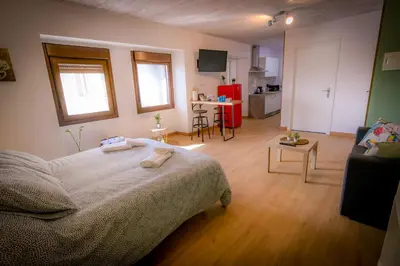 a bedroom with a bed and a living room at O Noso Recuncho in Palas de Rei