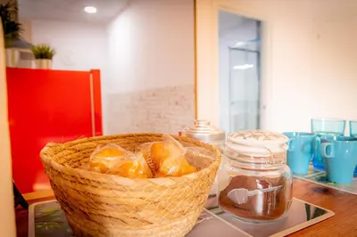 a basket of oranges sitting on a table with a jar at O Noso Recuncho in Palas de Rei