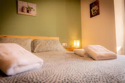 a bedroom with a bed with two pillows on it at O Noso Recuncho in Palas de Rei