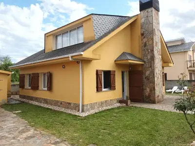 a house with a yellow at Casa Icaro in Barreiros