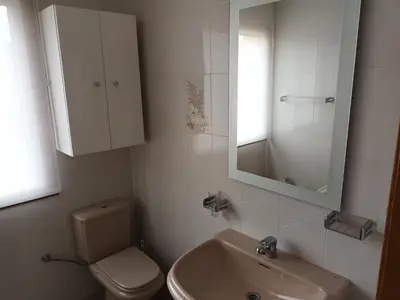a bathroom with a sink and a toilet and a mirror at Casa Icaro in Barreiros