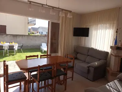 a living room with a table and a couch at Casa Icaro in Barreiros