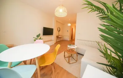 a living room with a white couch and a table and chairs at Noreas Centro Lucus Augusti in Lugo