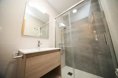 a bathroom with a sink and a glass shower at Noreas Centro Lucus Augusti in Lugo