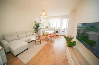 a living room with a white couch and a table at Noreas Centro Lucus Augusti in Lugo