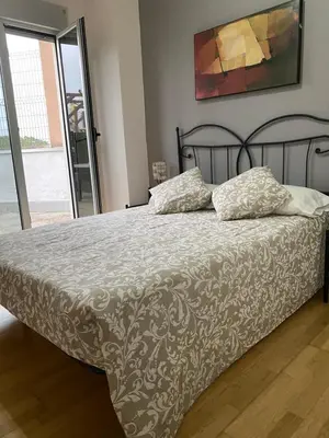 a bed with two pillows on it in a bedroom at Alargos Foz in Foz