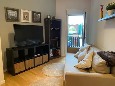 a living room with a couch and a flat screen tv at Alargos Foz in Foz