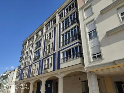 a building with a blue and white building at Alargos Foz in Foz