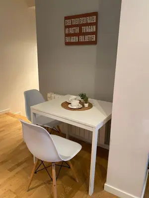 a white table with two chairs and a plate on it at Alargos Foz in Foz