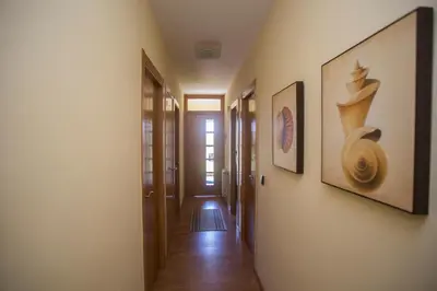 a hallway with two pictures on the wall and a hallway with a hallway at Apartamentos Sarela in Santiago de Compostela