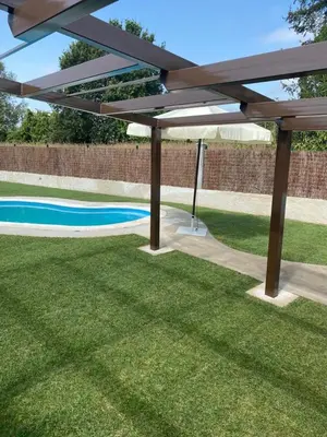 a picnic table in the grass next to a pool at CASA DO LAGOEIRO in Boimorto