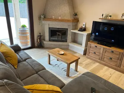 a living room with a couch and a fireplace at CASA DO LAGOEIRO in Boimorto