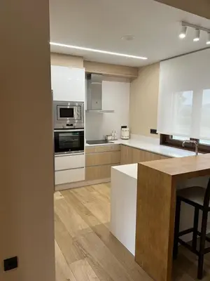 a kitchen with white cabinets and a counter top at CASA DO LAGOEIRO in Boimorto