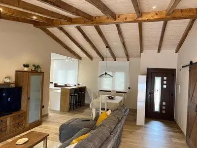 a living room with a couch and a kitchen at CASA DO LAGOEIRO in Boimorto
