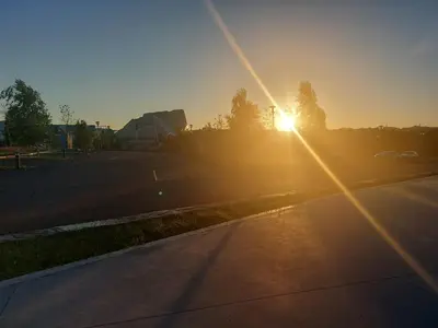 a sunset over a parking lot with the sun setting at Apartamento Vieiro con plaza garaje gratis in Santiago de Compostela