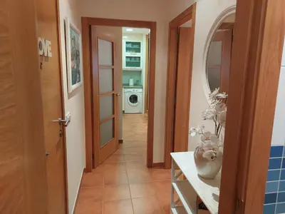 a hallway with a door leading to a laundry room at Apartamento Vieiro con plaza garaje gratis in Santiago de Compostela