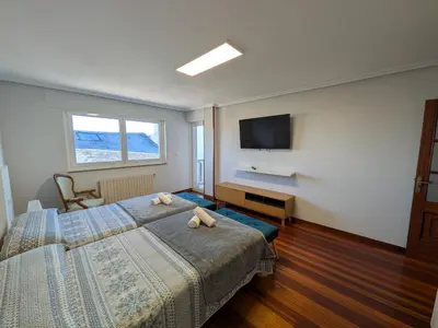 a bedroom with a bed and a flat screen tv at Casa-Nova Centro in Sarria