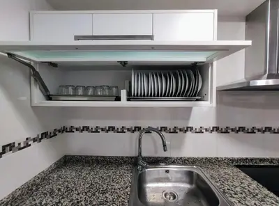 a kitchen with a sink and a shelf with dishes at Casa-Nova Centro in Sarria