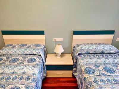 two beds sitting next to each other in a room at Casa-Nova Centro in Sarria