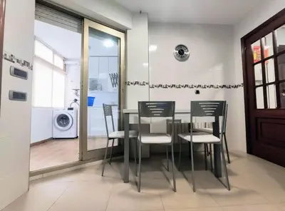 a dining room with a glass table and chairs at Casa-Nova Centro in Sarria