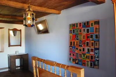 a hallway with a painting on the wall at Los Polvazares in Castrillo De Los Polvazares