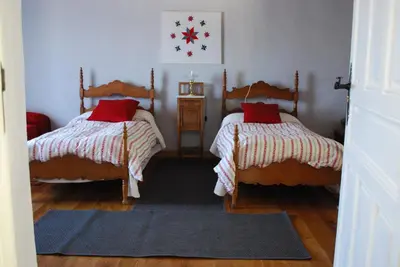 a bedroom with two beds with red pillows on them at Los Polvazares in Castrillo De Los Polvazares