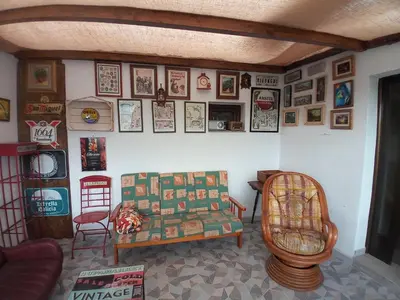 a living room with a couch and pictures on the wall at Hostal La Medina de Camponaraya in Camponaraya