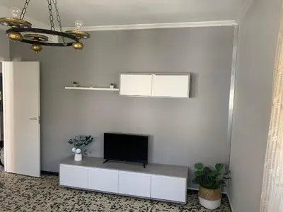 a living room with a tv on a white wall at Apt Sueiras in Burela de Cabo
