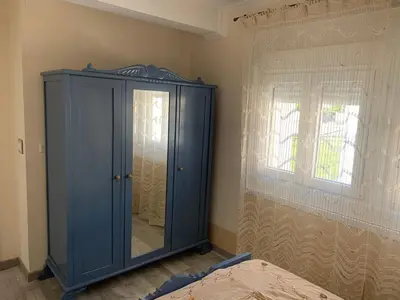 a blue cabinet in a room with a window at Apt Sueiras in Burela de Cabo