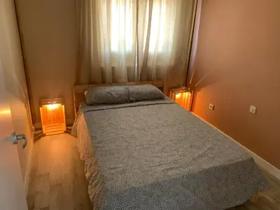 a small bedroom with a bed with two lights on it at Apt Sueiras in Burela de Cabo