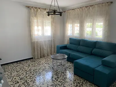 a living room with a blue couch and a table at Apt Sueiras in Burela de Cabo