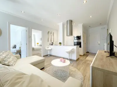 a living room with a white couch and a table at La Rúa de San Pedro by Clabao in Lugo