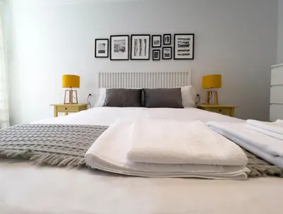 a bedroom with a white bed with two lamps at La Rúa de San Pedro by Clabao in Lugo