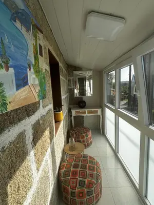 a room with two ottomans and a wall at Carballo Alenza in Sistín