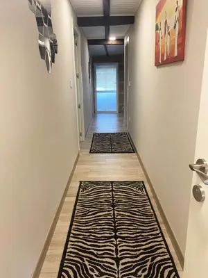 a hallway with a zebra print rug on the floor at Carballo Alenza in Sistín